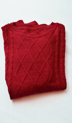 Folded red womens sweater on white background