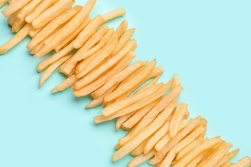 Tasty french fries on light blue background