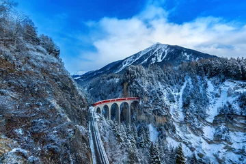 Wall murals Landwasser Viaduct Landscape of Train passing through famous mountain in Filisur, Switzerland. Landwasser Viaduct world heritage with train express in Swiss Alps snow winter scenery.