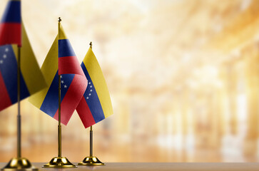 Small flags of the Venezuela on an abstract blurry background