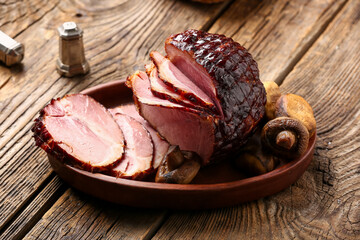 Plate with tasty smoked ham and grilled mushrooms on wooden background