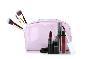 Cosmetic bag with makeup brushes and lipsticks on white background