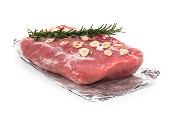 Aluminium foil with piece of raw meat, spices and rosemary on white background