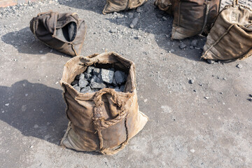 sack bags filled with coal waiting to be weighed on a weigh bridge