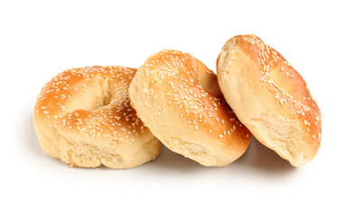 Tasty bagels with sesame seeds on white background