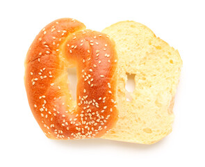 Halves of tasty bagel with sesame seeds on white background