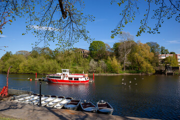 Canoes moored for tourist leisure at River Dee, Chester UK