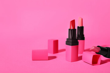 Different lipsticks on pink background