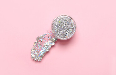Jar of silver glitter with stroke on pink background