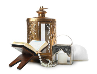 Muslim lamps with Koran and hat on white background