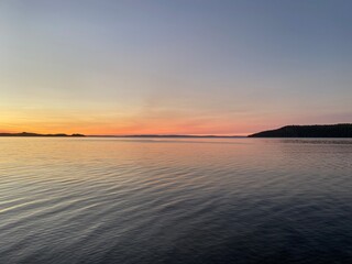 Beautiful Lake Superior in Thunder Bay Ontario during sunset with Blue water and mountains in the background