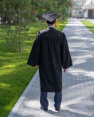 Rear view of an elderly man in a graduation gown. 