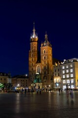 Plakat Krakow main square church at night with people in ghost effect