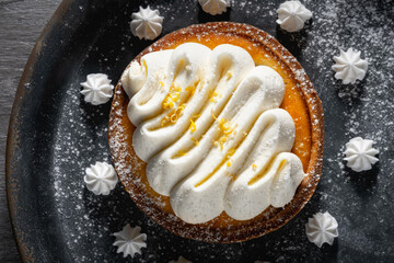 Cake with cream in a gray plate