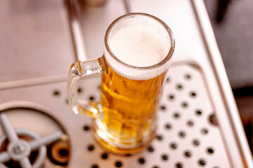 Top view of Freshly tapped beer in a bar