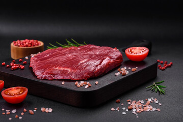 Fototapeta na wymiar Fresh raw beef with salt, spices and herbs