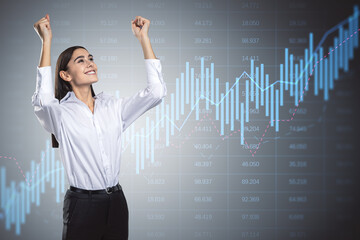 Happy young businesswoman with glowing candlestick forex chart on gray background with index. Trade, stock and global finance concept. Double exposure.