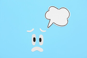Sad smile with speech bubble on blue background. Dialogue concept