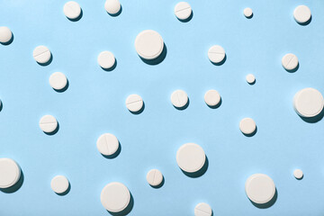 White pills on blue background