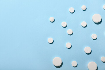 White pills on blue background