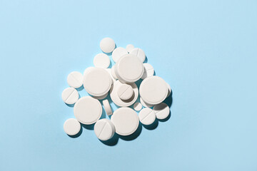White pills on blue background