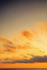 golden sunrise at the sea. fluffy clouds cover the sun above horizon. good weather forecast on summer vacation