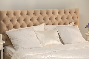 White pillows, duvet and duvet case on a beige king size bed