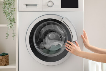 Woman doing laundry at home, closeup