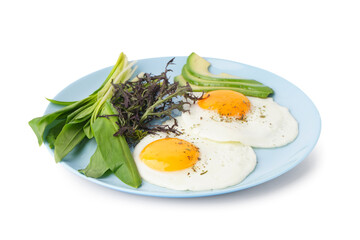 Plate with tasty fried eggs and greens on light background
