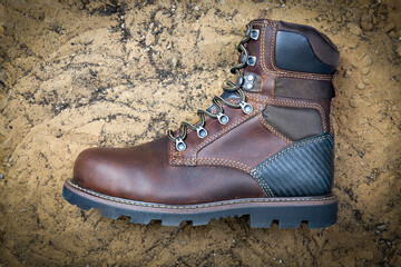 safety shoes on sand, top view