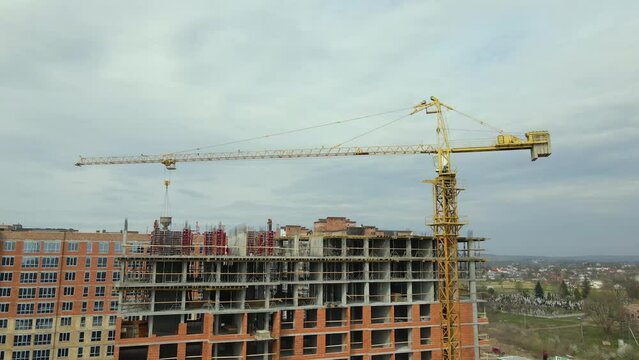 Tower cranes and frame structure of high residential apartment buildings at construction site. Real estate development