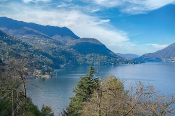 Fototapeta na wymiar Como city in Italy, view of the city from the lake, with mountains in background 