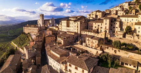Fototapeten Impressive medieval Assisi town in Umbria over sunset. Italy.  aerial drone panoramic view. italian travel and best destinations © Freesurf