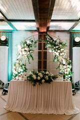 The table is beautifully decorated with flowers and tablecloths for the newlyweds wedding decor