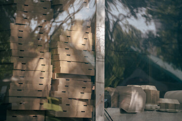 Reusable recycled brown takeaway packaging in window of foodtruck