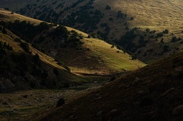 A hillside illuminated by morning light in the Turkestan Mountains in Kyrgyzstan.