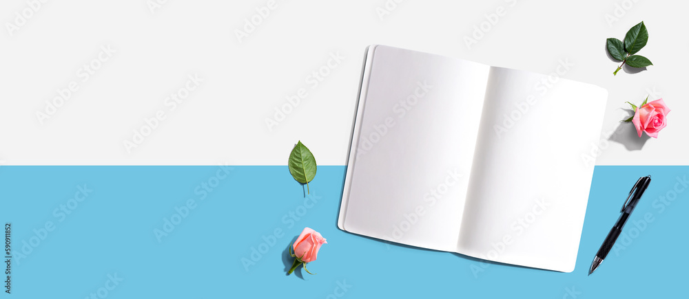 Poster open notebook or diary with a pen from above with rose buds- flat lay