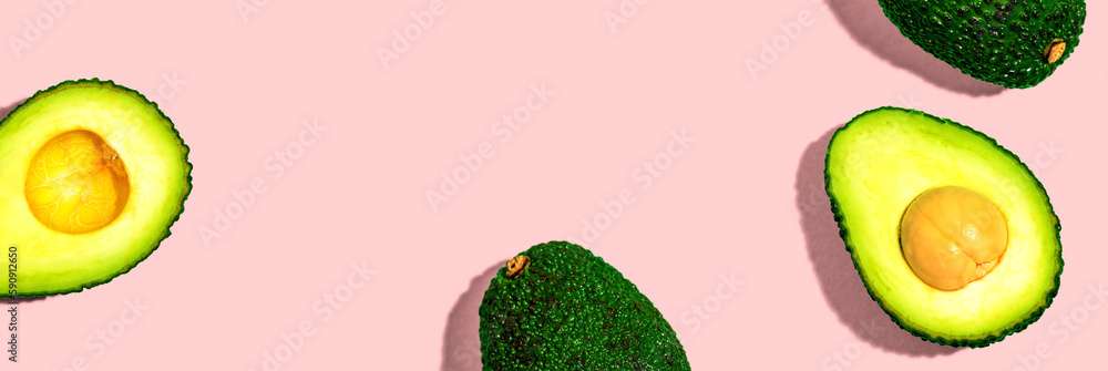 Wall mural fresh avocado halves overhead view - flat lay