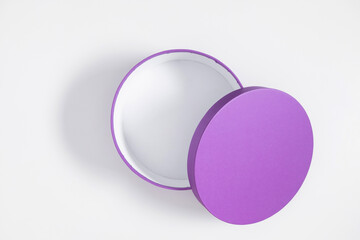 Open purple round gift box isolated on white background. Flat lay, top view, copy space