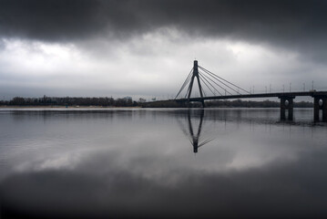 Black and white cityscape. North Bridge in Kyiv in the reflection of the Dnieper