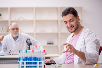 Fototapeta premium Two male chemists working at the lab