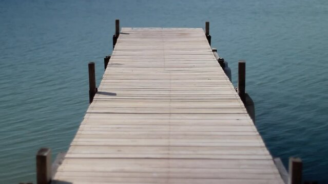 An empty wooden dock on the water.