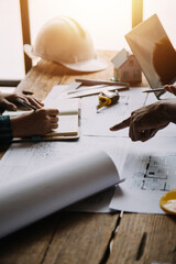 Construction and structure concept of Engineer or architect meeting for project working with partner and engineering tools on model building and blueprint in working site, contract for both companies.