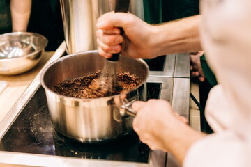 Obraz na płótnie Canvas chef cooks mixture cream making dessert chocolate