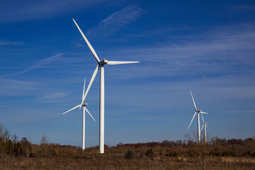  Wind turbines against blue sky background.