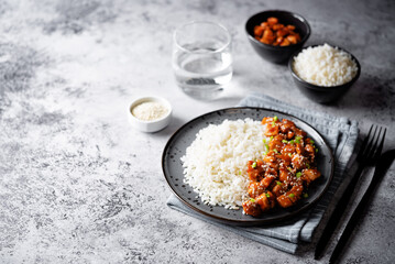 Sweet and sour chili sauce chicken with rice in a plate
