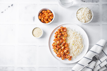 Sweet and sour chili sauce chicken with rice in a plate