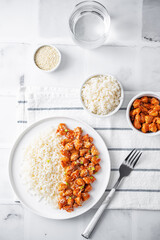 Sweet and sour chili sauce chicken with rice in a plate