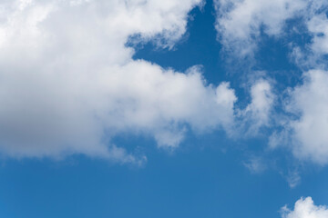 A blue sky with clouds and a white cloud