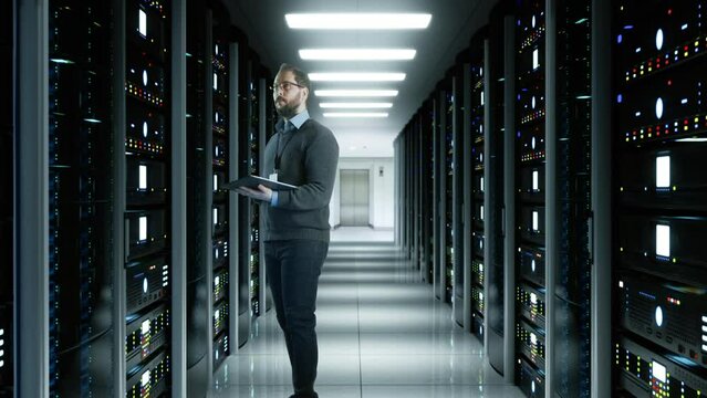 System Administrator Man With A Tablet In A Futuristic High Tech Server Room. Camera move forward. IT Technician 3d render concept. Crypto Currency Mining. Bitcoin farm. Prores 10 Bit HQ mov.